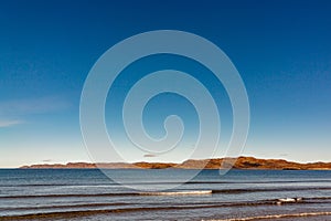 Wave on the sandy shore in the Teriberskaya Bay. Far North, Barents Sea in Russia