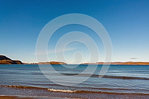 Wave on the sandy shore in the Teriberskaya Bay. Far North, Barents Sea in Russia