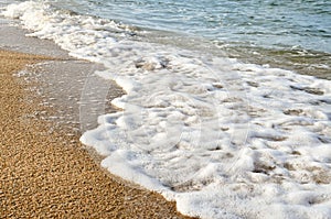 Wave of the sea on the sand beach