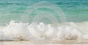 Wave of the sea swashing up onto sand beach, summer background