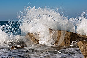 Wave Smashing Rocks