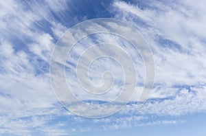 Wave of softy and white fluffy clouds under deep blue sky