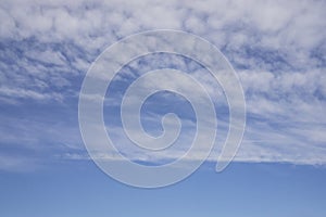 Wave of softy and white fluffy clouds under deep blue sky