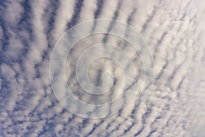 Wave of softy and white fluffy clouds  under deep blue sky