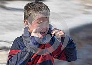 Wave splashed all over a 6 year old boy photo