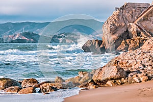 Wave splashes close-up. Crystal clear sea water hitting rock formations in the ocean in San Francisco Bay, blue water, pastel