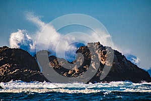 Wave splashing against a rock in the sea