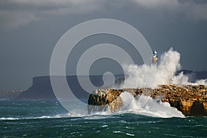 Wave splashing in Mouro lighthouse in Santander photo