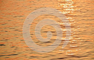 Wave on water surface on sea in sunset background and texture