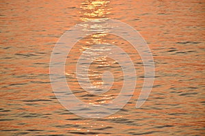 Wave on water surface on sea in sunset background and texture