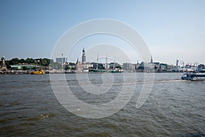 Waveless calm water surface and Hamburg harbor skyline with modern buildings along the Elbe river