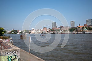 Waveless calm water surface and Hamburg harbor skyline with modern buildings along the Elbe river