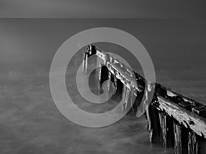 Waves against old wooden pylons