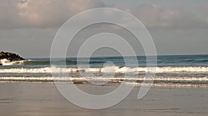 Waves along the beach in summer