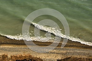 Waves along Lake Michigan shoreline break on the beach