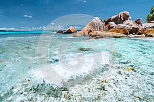 Waves of Anse Cocos at la Digue island, Seychelles. Secluded beautiful tropical beach with rocks in ocean