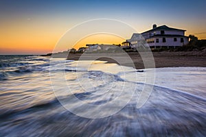 Waves in the Atlantic Ocean and beachfront homes at sunset, Edisto Beach, South Carolina.