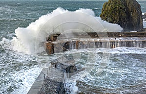 Waves batter the harbour, Mullion Cove, Cornwall