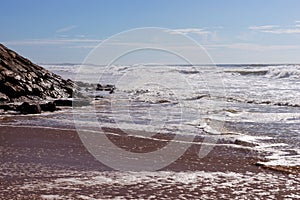 Waves on the beach Areia Branca. West coast of Portugal photo