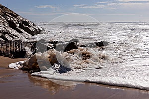 Waves on the beach Areia Branca. West coast of Portugal photo