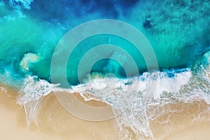 Waves and beach. Coast as a background from top view. Turquoise water background from air. Nusa Penida island, Indonesia.