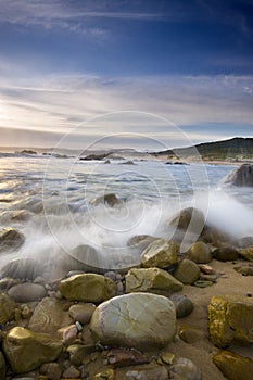 Waves on beach rocks