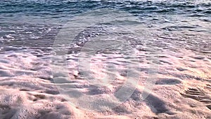 Waves on beach sand background. Slow motion video