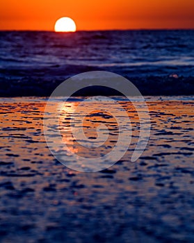 Waves on beach at sunset