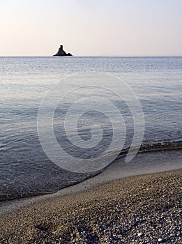 Waves and beautiful sunset on the Greek island Evia Euboea in the Aegean Sea