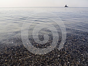 Waves and beautiful sunset on the Greek island Evia Euboea in the Aegean Sea