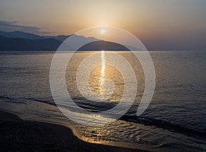 Waves and beautiful sunset on the Greek island Evia Euboea in the Aegean Sea