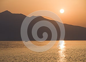 Waves and beautiful sunset on the Greek island Evia Euboea in the Aegean Sea