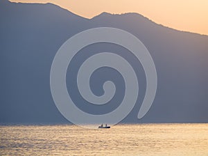 Waves and beautiful sunset on the Greek island Evia Euboea in the Aegean Sea