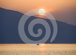 Waves and beautiful sunset on the Greek island Evia Euboea in the Aegean Sea