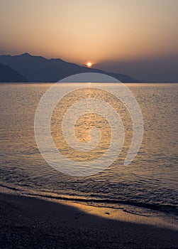 Waves and beautiful sunset on the Greek island Evia Euboea in the Aegean Sea