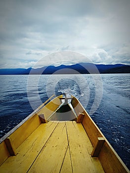 Waves behind a wooden boat in portrait