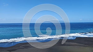 Waves on the black sand beach of Fonti Billa in Fogo Cape Verde