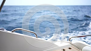 waves of a boat on the blue sea with splashes and a wake from a yacht. Travel and journey concept