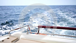 waves of a boat on the blue sea with splashes and a wake from a yacht. Travel and journey concept