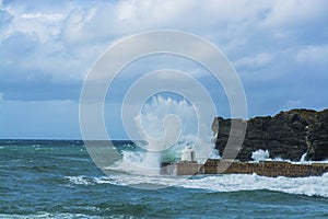 Waves braking on portreath breakwater at Cornwall