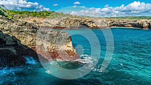 Waves break against the rocks island Nusa Lembongan, Indonesia