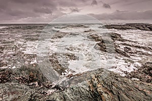 Waves break against the rocky coastline in Newport, Rhode Island