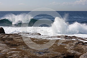 Waves break along rocky shore