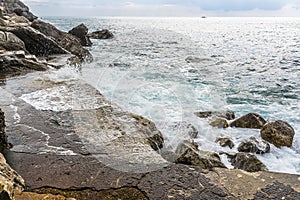 Waves break on the quayside at Gavitella Beach in Praiano. Italy on the Amalfi coast