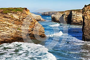 Waves break about rocks