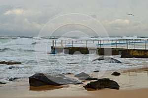 Waves break on a sandy beach in Sydney, Australia