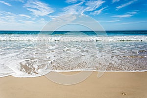 Waves breaking on beach with blue sky - Port Elizabeth, South Af