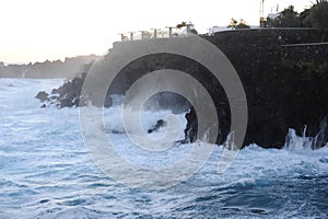 Waves breaking and crushing on the rocks on the Atlantic Ocean on coastline and seashore of Madeira Island , Portugal