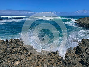 Waves breaking over rocks at Islote Sancho, Riviere Des Galets, Mauritius