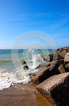 Waves breaking on rocks along beach